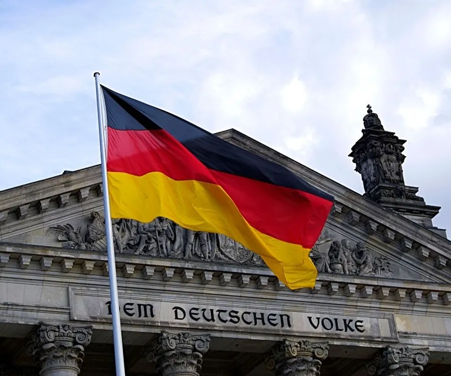 German flag flying in front of a historic government building in Berlin